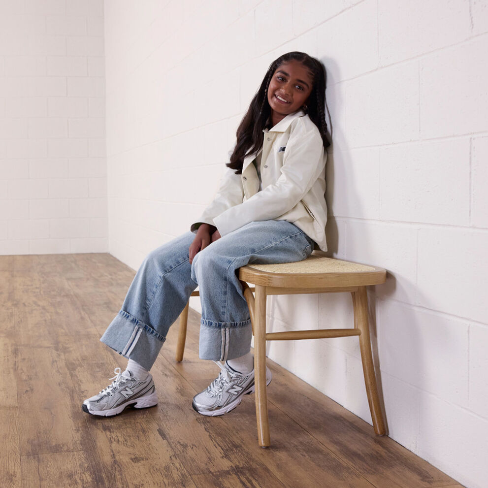 Girl sitting on wooden stool, wearing the 740 
